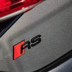 Stilrent Audi RS emblem i blanksvart – perfekt för bakluckan och en sportigare känsla.